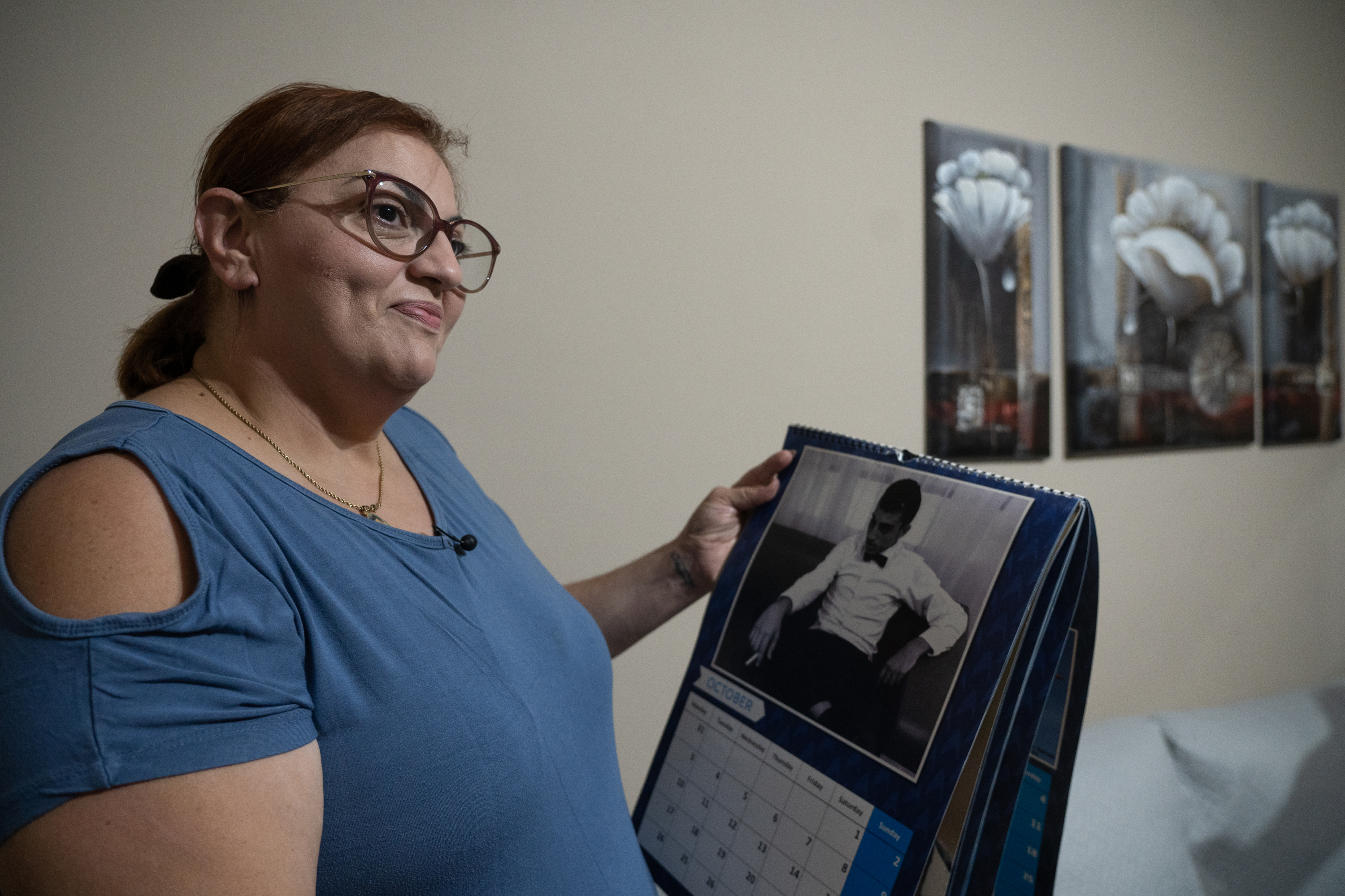 Claudette Bartolo looking at a calendar of her son Matthew, who died at his place of work in 2015, aged only 17 (Photo: James Bianchi/MaltaToday)