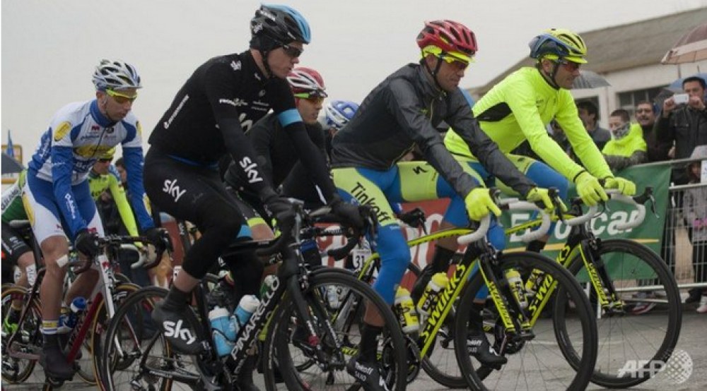 Team Sky's British Cyclist Christopher Froome (2nd L), and Tinkoff Saxo's Spanish Cyclist Alberto Contador (2nd R) during the start four stage