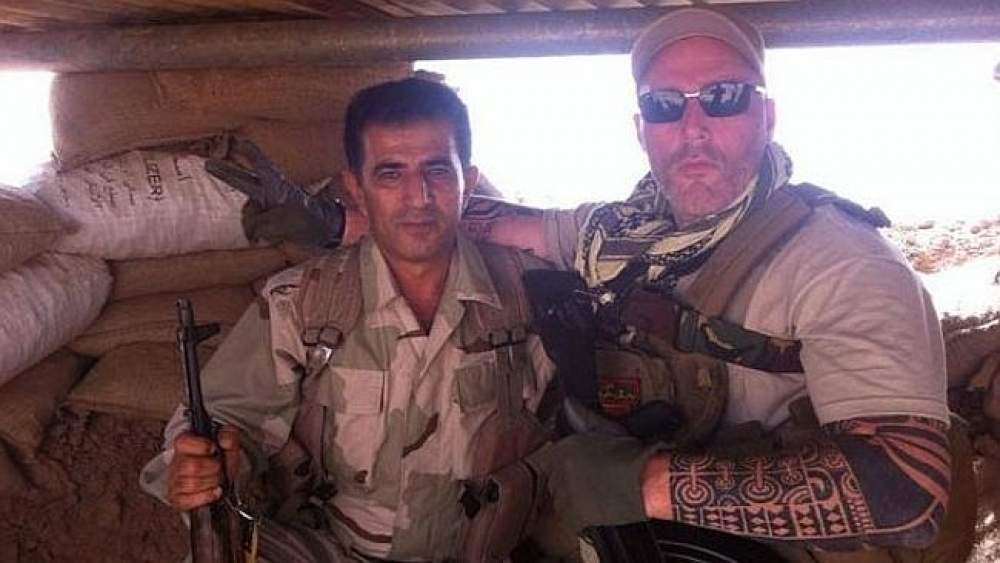 No Surrender ... a Dutch bikie flashes the victory sign alongside a new Kurdish comrade in Iraq. Photo: Twitter