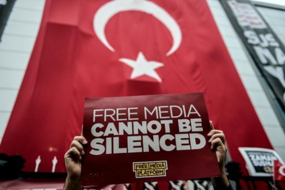 Protestors hold up signs in support of Kanalturk and Bugun TV after a police crackdown on media houses that oppose President Erdogan