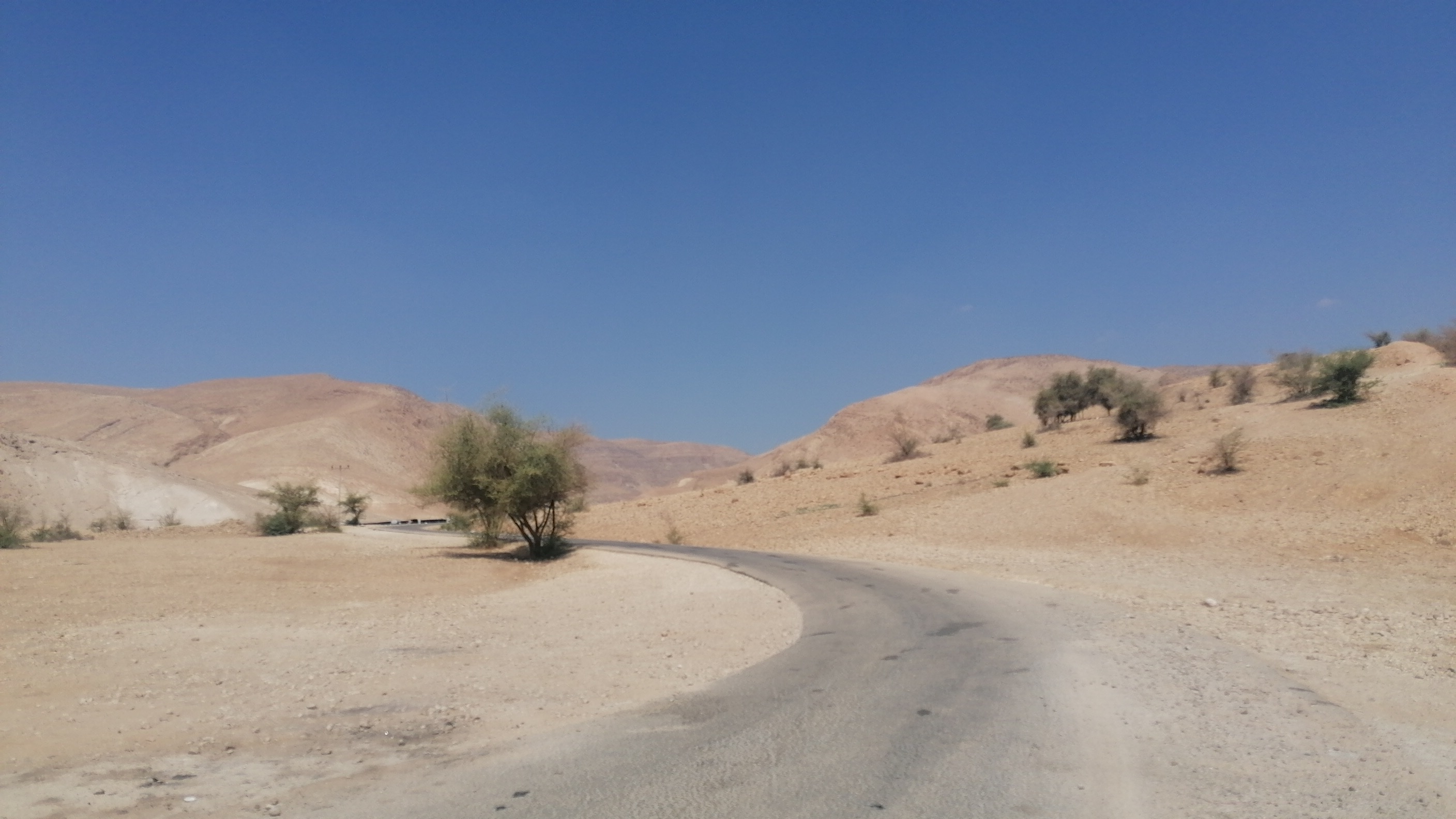The road to the Bedouin village winds through arid terrain