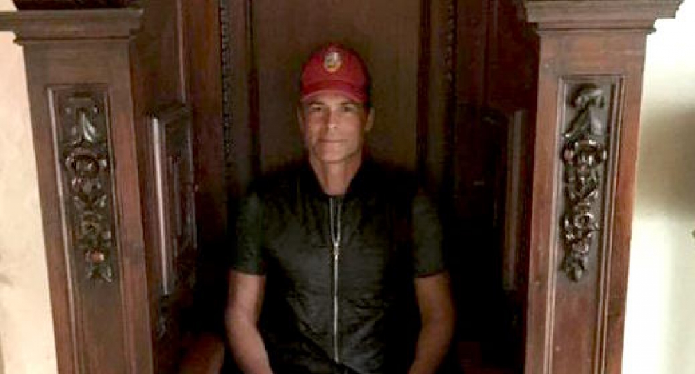 Actor Rob Lowe tries on a confessional for size on his Malta film set