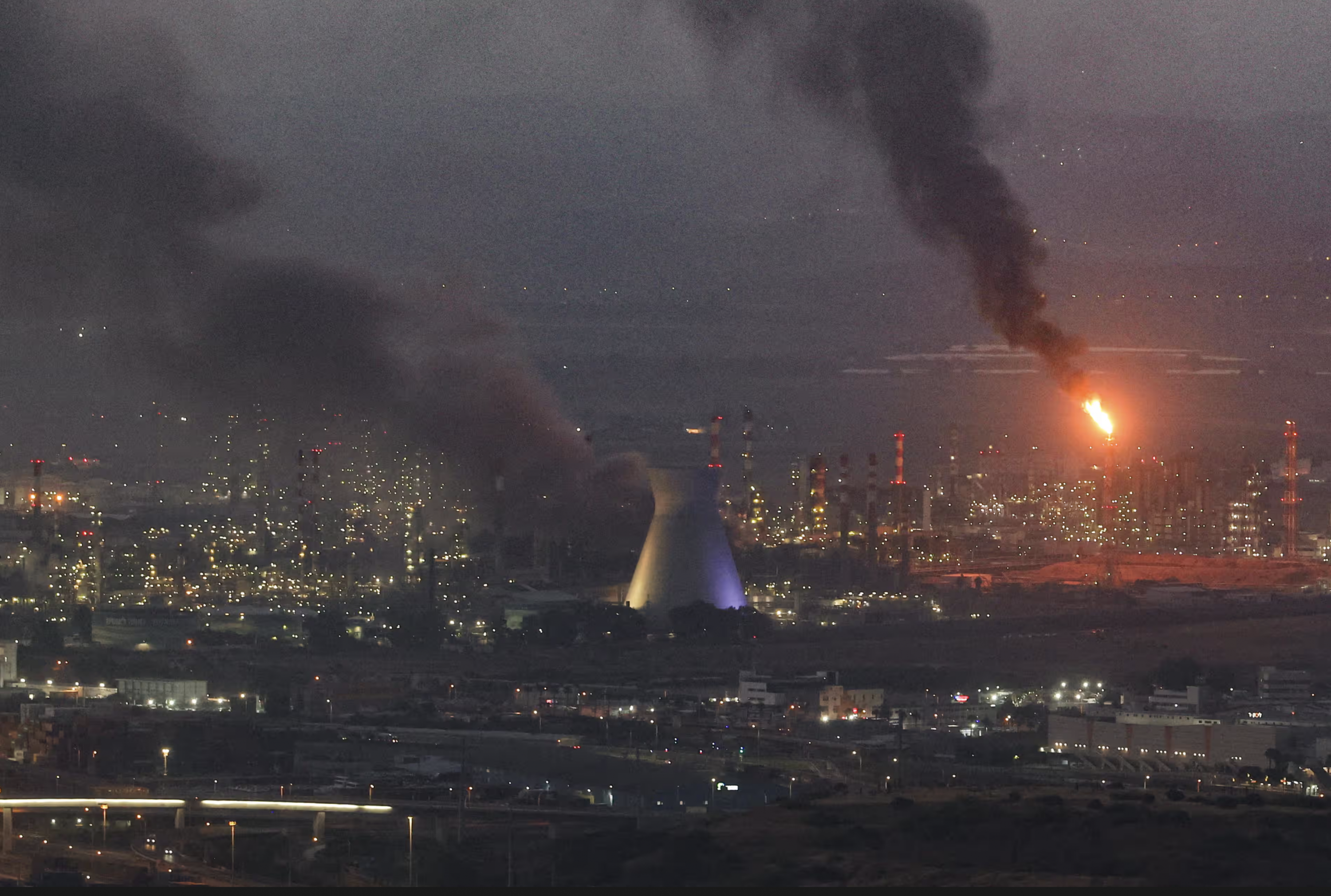 Smoke billows from a site in the city of Haifa on Monday after a fresh barrage of Iranian missiles