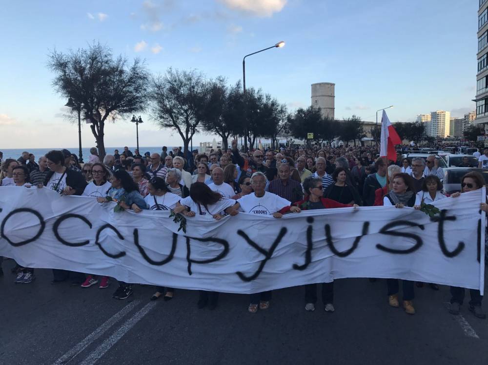 Demonstrators are walking along the Sliema promenade demanding justice for Daphne Caruana Galizia