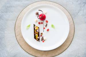 Hazelnut praline and orange cream with raspberry-glazed, white chocolate sphere