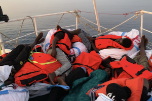 Updated | Stranded migrant vessel receives water and food as standoff enters second day