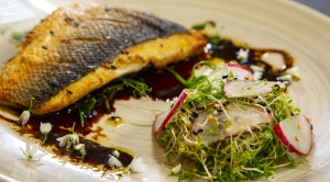 Sea bass with stir fried pea shoots & cress salad