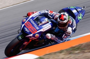 Lorenzo breaks lap record to take pole