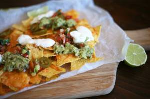 Cheesy nachos with guac, tomato salsa and sour cream