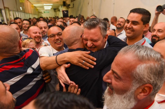 Tourism Minister Konrad Mizzi embracing Alfred Zammit who will be the first PL Mayor in Valletta