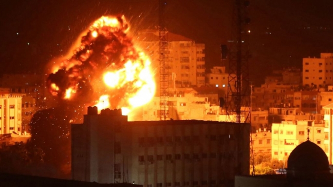 Flames and smoke are seen during an Israeli air raid in Gaza City