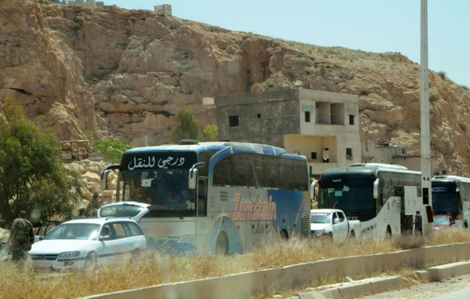 Syrian rebels, families start leaving Damascus neighborhood