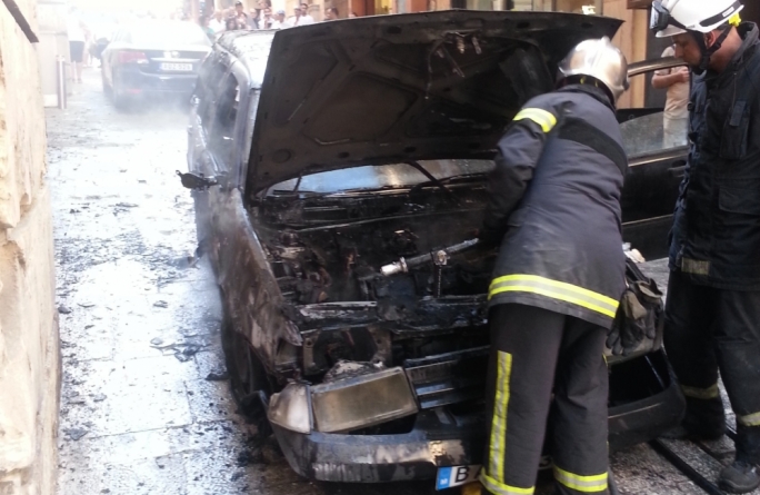 Civil Protection personnel inspect the vehicle after it was gutted by flames early in the morning.