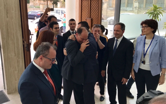 An emotional Godfrey Farrugia is welcomed by the PN whip David Agius