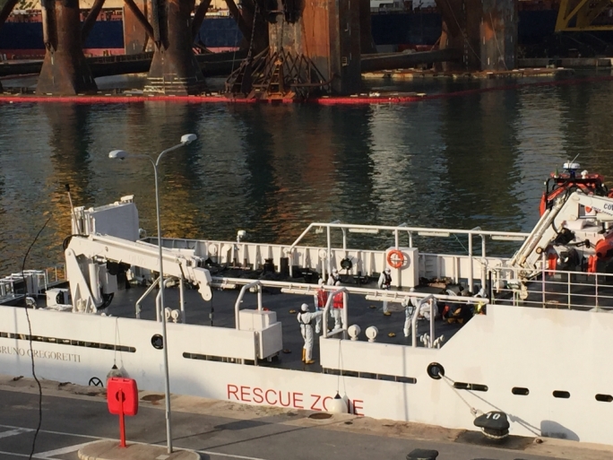 Body bags on the decks of the coast guard vessel