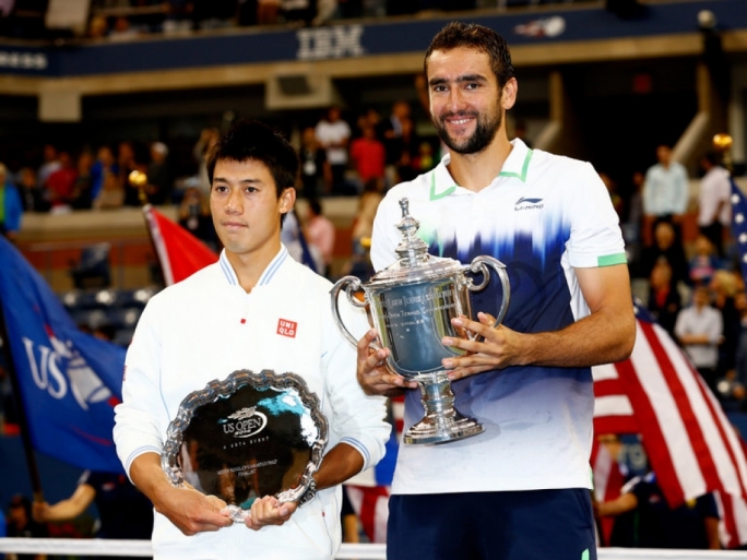 Kei Nishikori and Marin Cilic of Croatia pose with trophies at the US Open