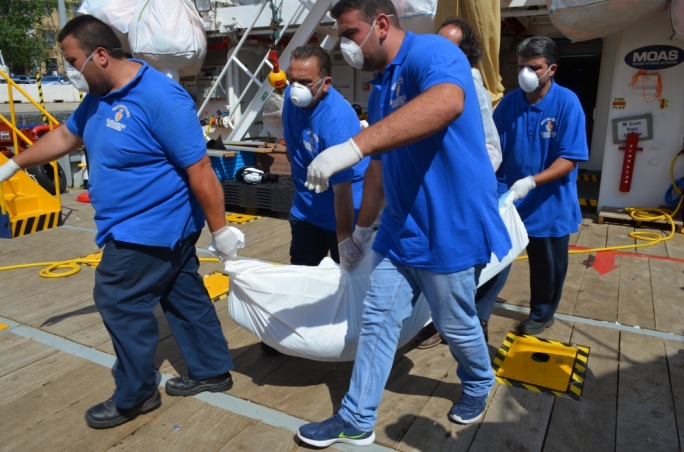 An unidentified migrant who lost his life at sea is removed from the Phoenix vessel operated by MOAS. Photo: Miriam Dalli