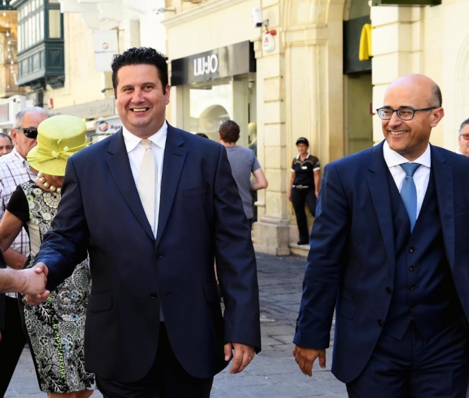 Smart Edward Zammit Lewis sporting a hand-woven silk tie whilst the fashionable Jason Azzopardi in a three-piece suit and a tie with a double Windsor knot