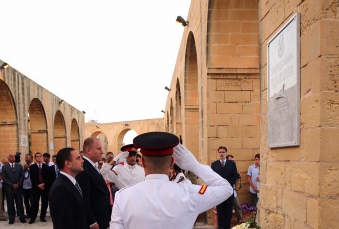 Justice minister Owen Bonnici (left) salutes the memory of the 13 sailors who died aboard the Kujawiak