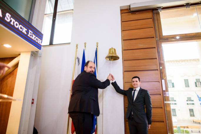 AST Group CEO Mr Emmanouil Kalamaras and Chairman Mr Giuseppe Muscat ring the bell at the Malta Stock Exchange marking the admission of the AST Group plc bond on the Prospects MTF market
