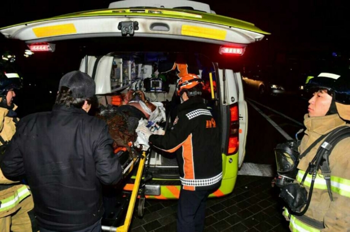 The injured Buddhist monk who set himself on fire is put into an ambulance in Seoul
