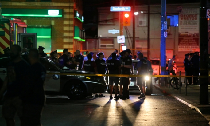 Police are seen at the busy avenue after the shootout (Photo: Chris Helgren/Reuters)