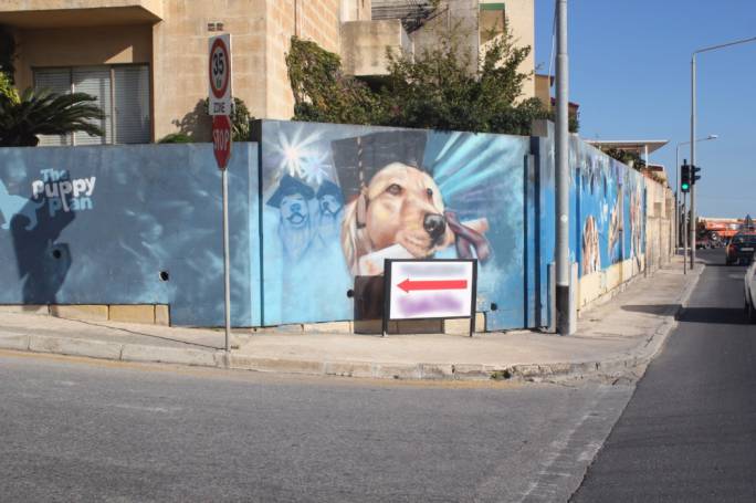Pavement signage placed in front of the mural is to be moved elsewhere