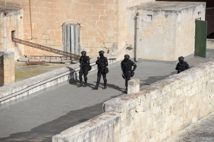 Armed police searching the properties in Marsa