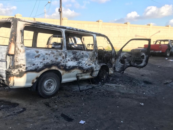 A van, one of five vehicles burnt during the riot