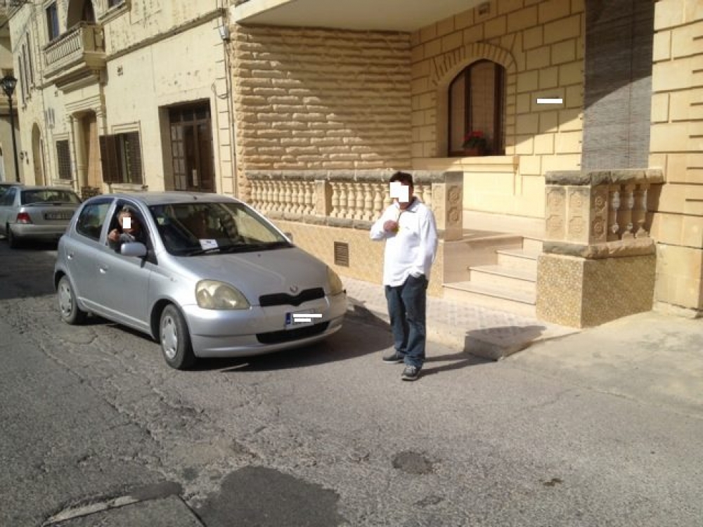 A mobile phone photo of two Iva canvassers in Qala reportedly canvassing voters as they make their way to the polling station.
