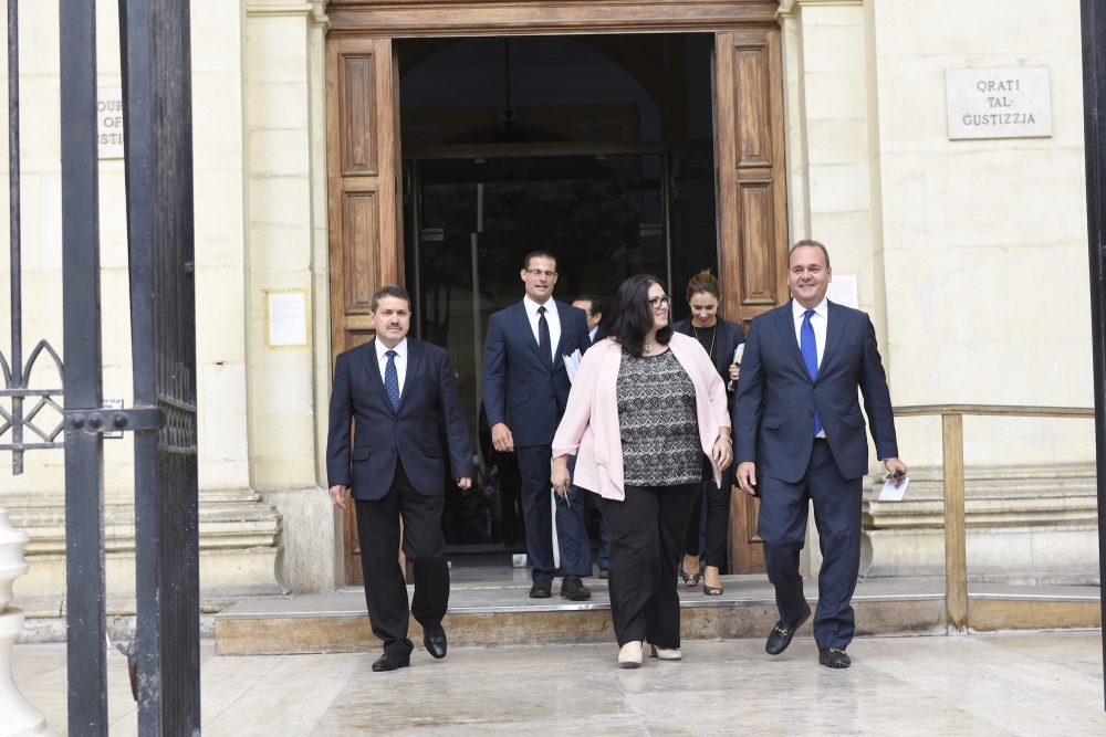 PArliamentary secretary Deborah Schembri and economy minister Chris Cardona exiting the law courts with lawyer Robert Abela (second from left)