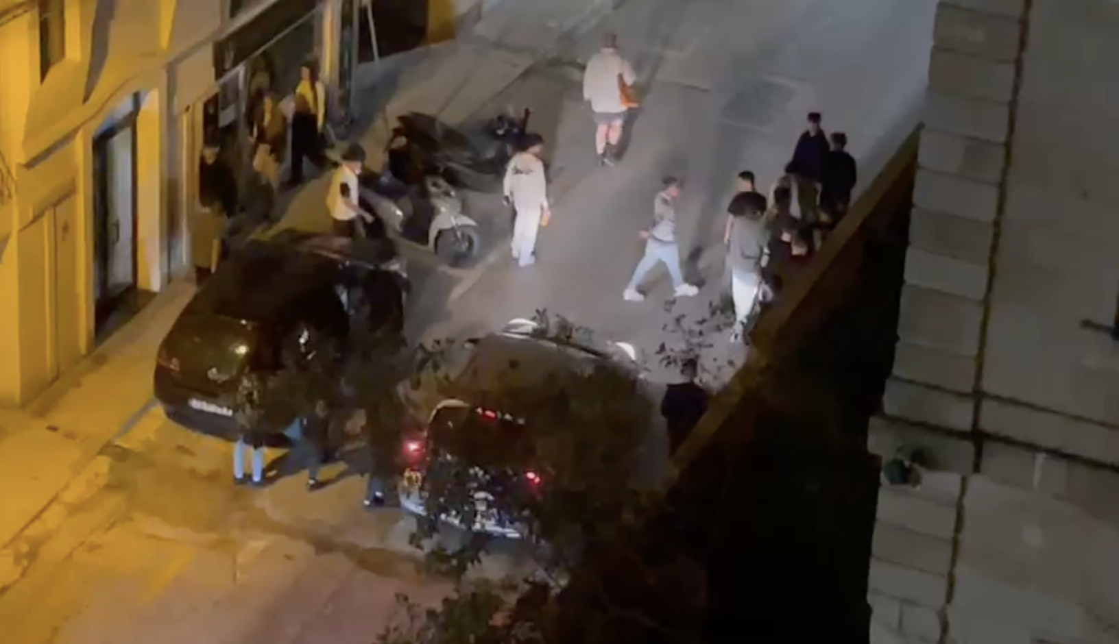 Youths stop cars driving through an adjacent street to Bisazza 