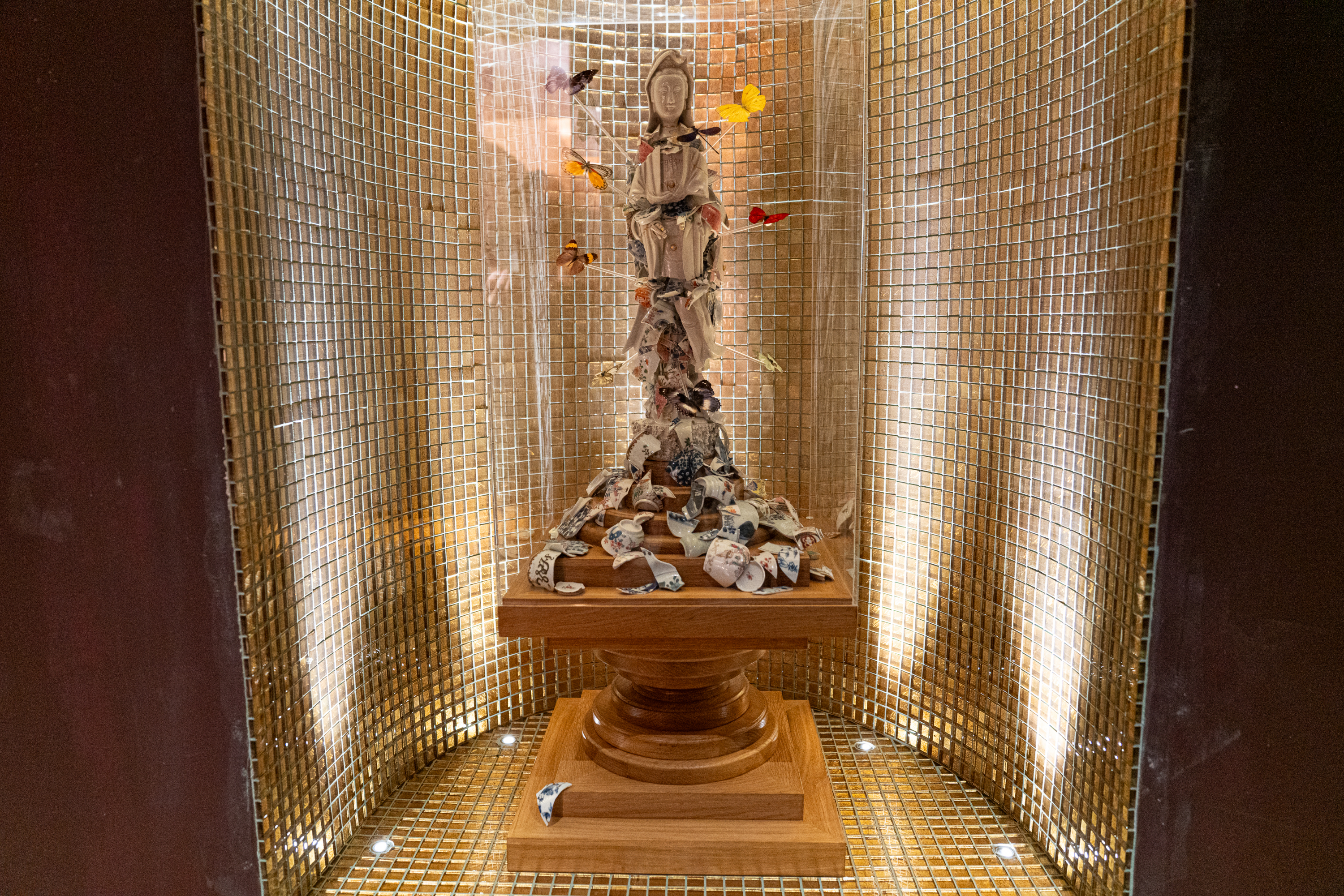 A statue made up of broken pieces of fine bone china