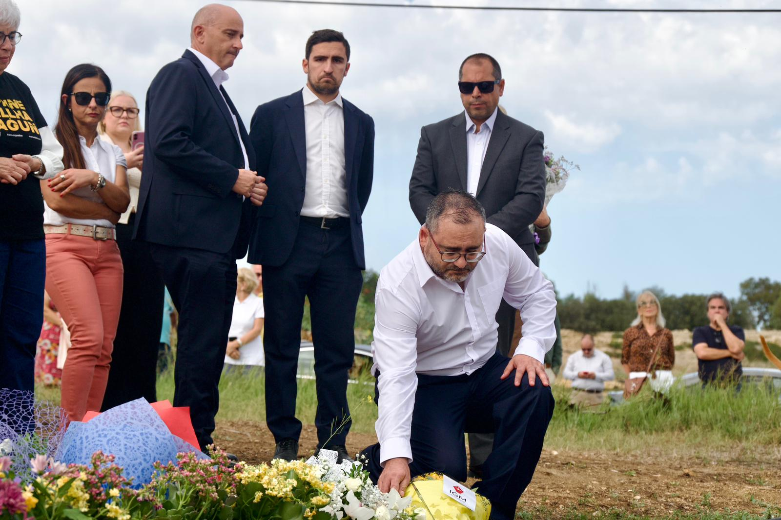 An IGM representative lays flowers as PN secretary general Charles Bonello and official Joseph Grech (first and second from left) stand behind (Photo: Miguela Xuereb/Newsbook)