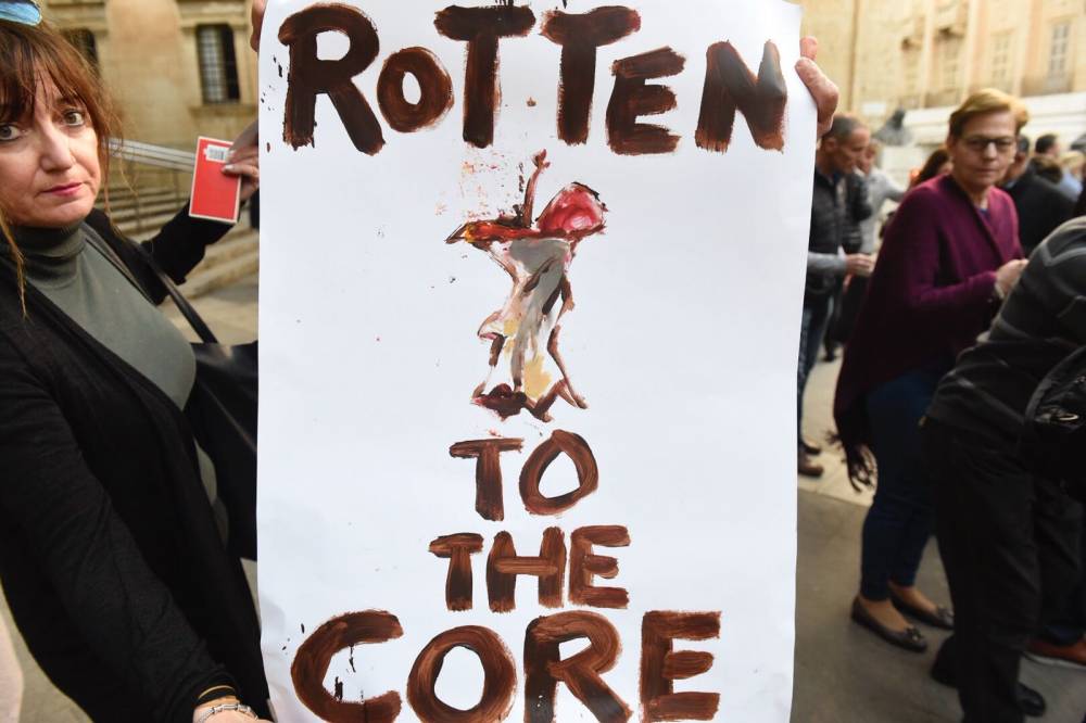 A sign during the vigil marking six months since Caruana Galizia's murder