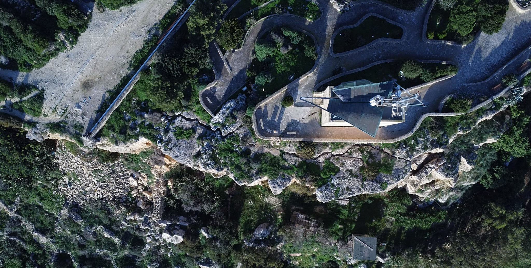 Arial photos show a sizeable crack in the cliff beneath the tower