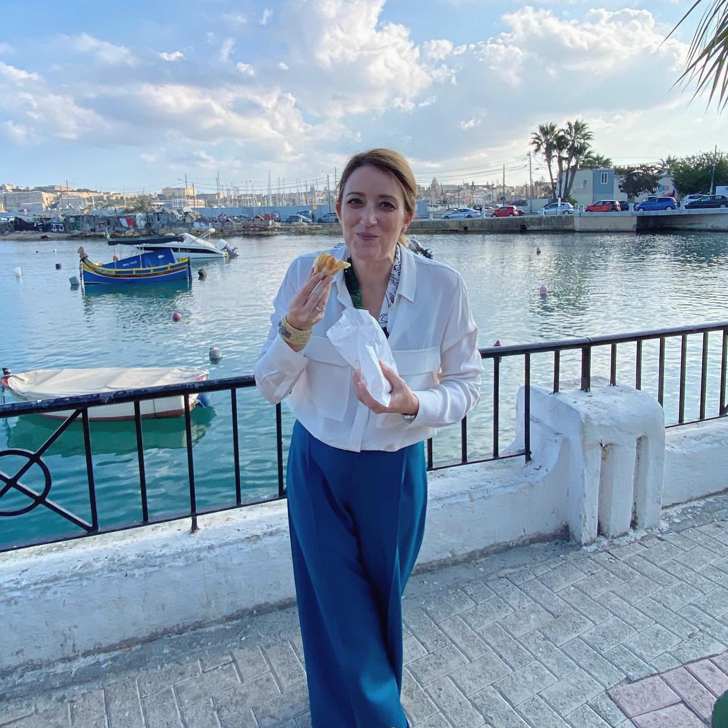 European Parliament President Roberta Metsola eats a pastizz during a visit back to Malta 