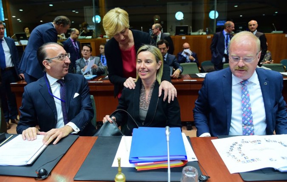 Italian defence minister Roberta Pinotti speaks to EU foreign policy chief Federica Mogherini