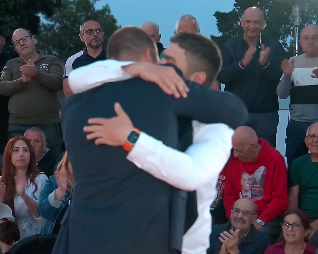 Prime Minister Robert Abela hugs Omar Rababah at the end of his speech 
