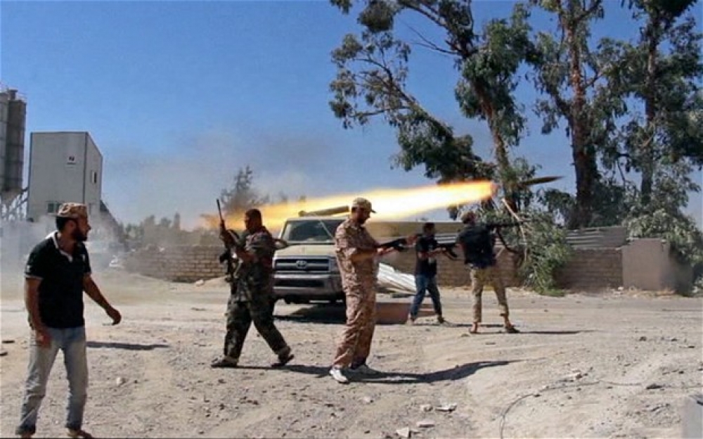 Fighters from the Islamist Misarata brigade fire towards Tripoli airport in an attempt to gain control from the powerful Zintani militia, in Tripoli, Libya.