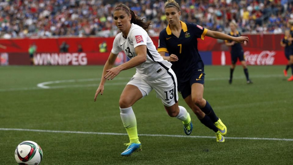 United States forward Alex Morgan (13) and Australia defender Steph Catley (7) chase the ball in a Group D soccer match in the 2015 women's World Cup at Winnipeg Stadium 