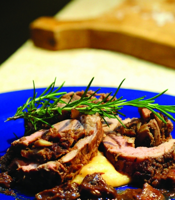 Pork fillet stuffed with prunes on a potato and pumpkin purée