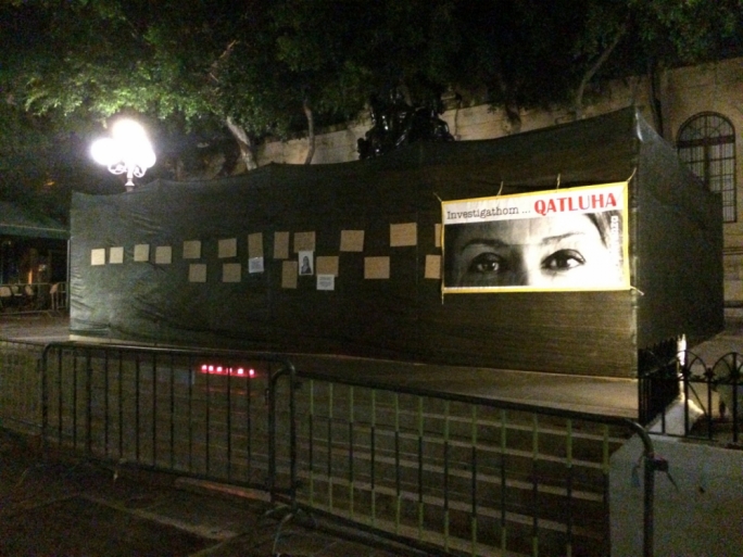 Activists plaster Caruana Galizia posters as memorial gets boarded up